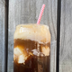 Espresso soda float against wooden fence backdrop